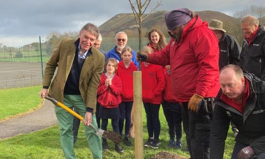 Philip Dunne plants cherry tree at Church Stretton School for BlossomWatch around National Tree Week