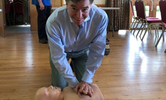 Philip Dunne brushes up his life-saving skills with members of Ludlow Defib4You.